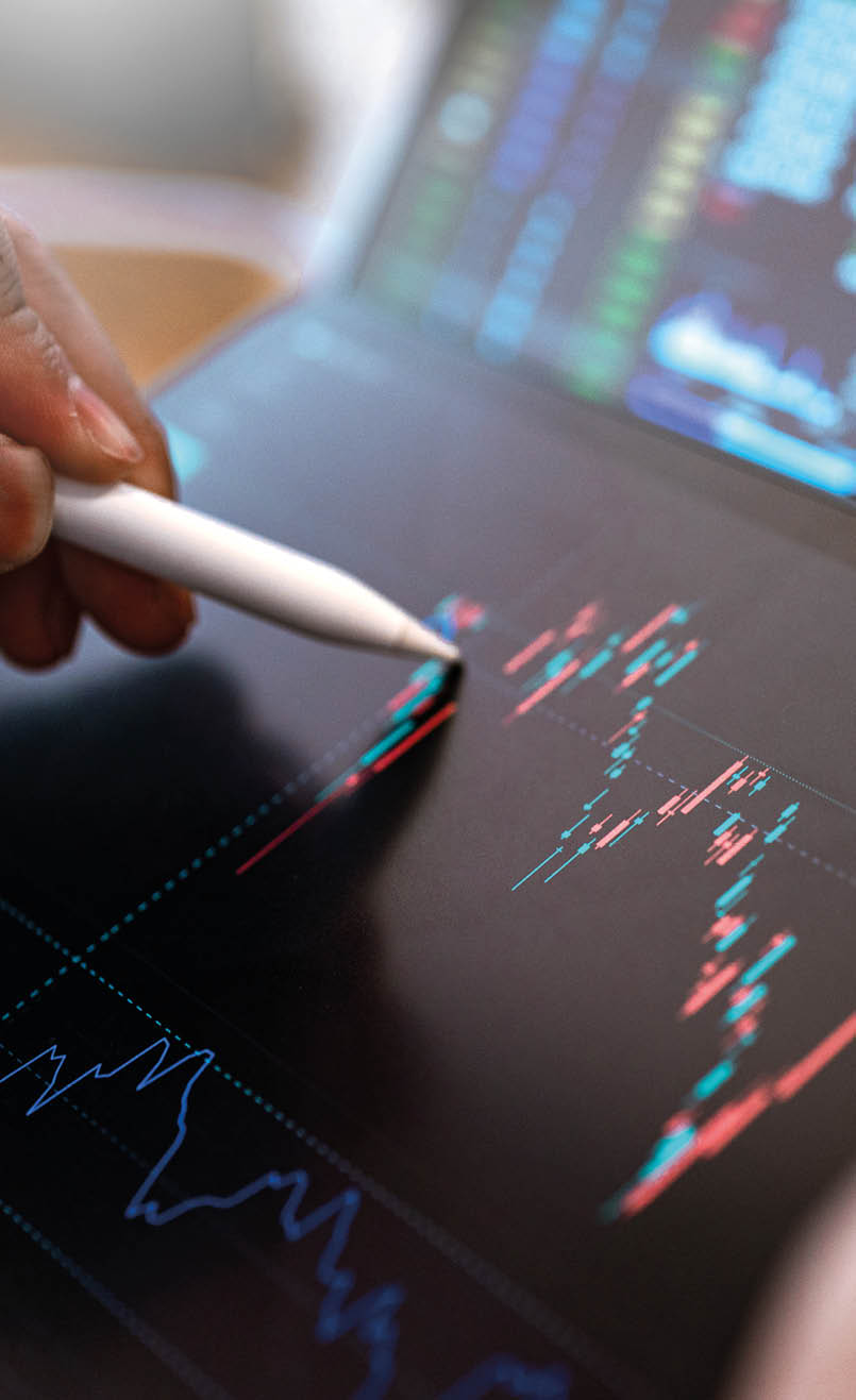 Market Analyze with Digital Monitor focus on tip of finger.