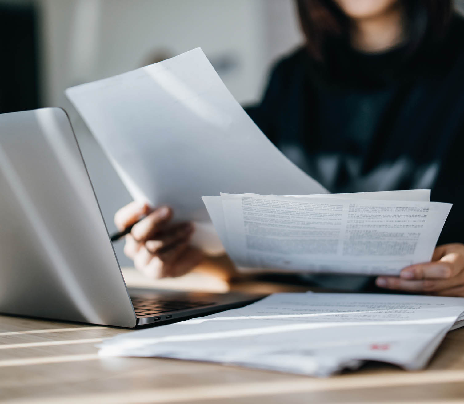 Cropped shot of young Asian woman handling personal banking and finance with laptop at home. Planning budget and calculating expenses. Managing taxes and financial bills. Wealth management. Digital banking habits. Smart banking with technology
