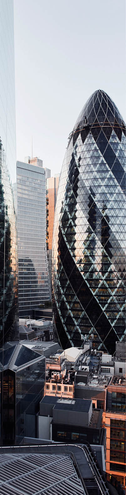 UK, London, elevated view of city financial district skyline illuminated at sunset